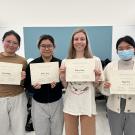 Four students holding up Dr. Elizabeth Prado Research Award certificates
